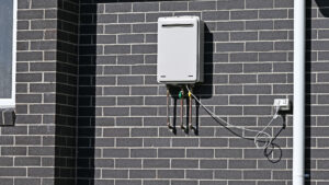 Tankless water heater on side of building